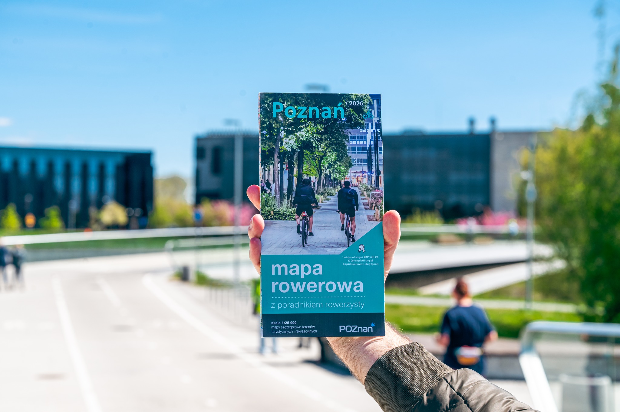 Zdjęcie przedstawia mapę rowerową na tle mostu.